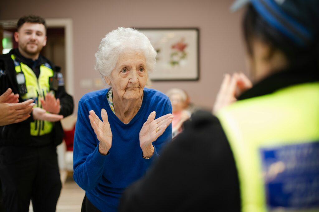 age-cymru-dxVDFXW3aAI-unsplash Elderly woman with dementia feeling happy and engaged with family and community support