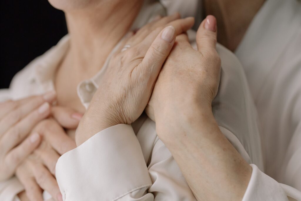 "daughter comforting elderly mother with dementia"