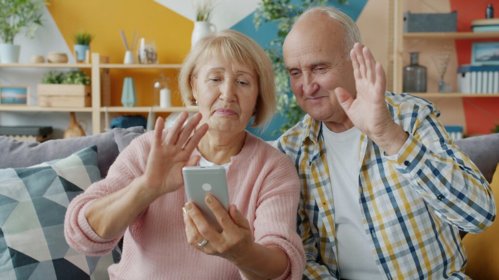 Elderly woman on video call with family staying connected to prevent loneliness and dementia